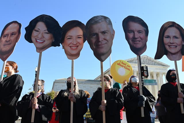 <p>Abortion rights activists carry cutouts of members of the Supreme Court</p>