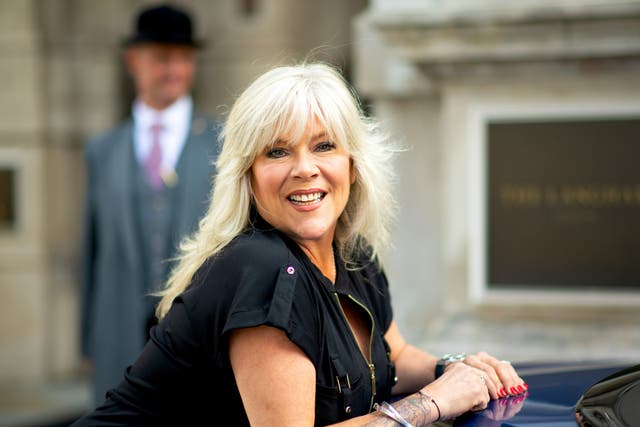<p> Samantha Fox poses with the rainbow Bentley during the "Henpire" podcast launch event at Langham Hotel on September 10, 2020</p>