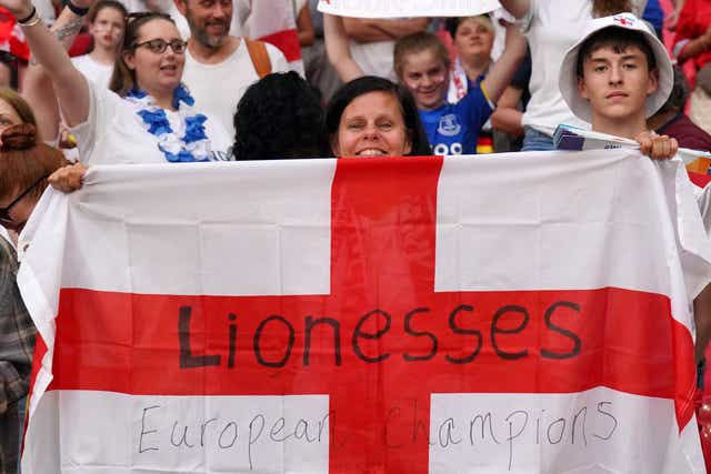 An England fan holds a flag in the stands as England celebrate winning the Uefa Women’s Euro 2022 final (Jonathan Brady/PA)
