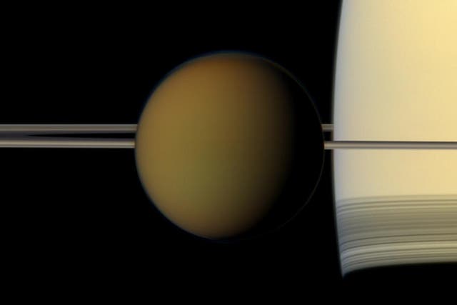 <p>Crucible of life? Titan, in front of Saturn’s rings</p>