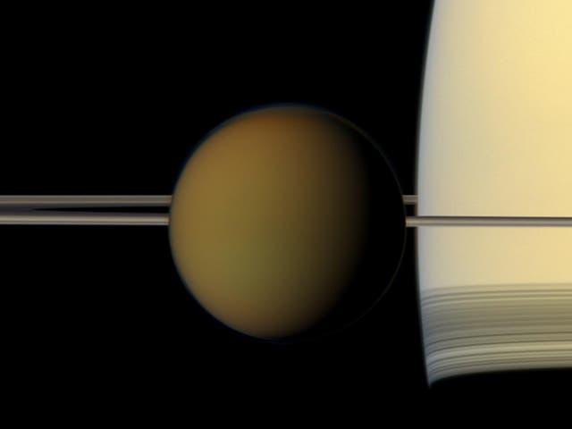 <p>Crucible of life? Titan, in front of Saturn’s rings</p>