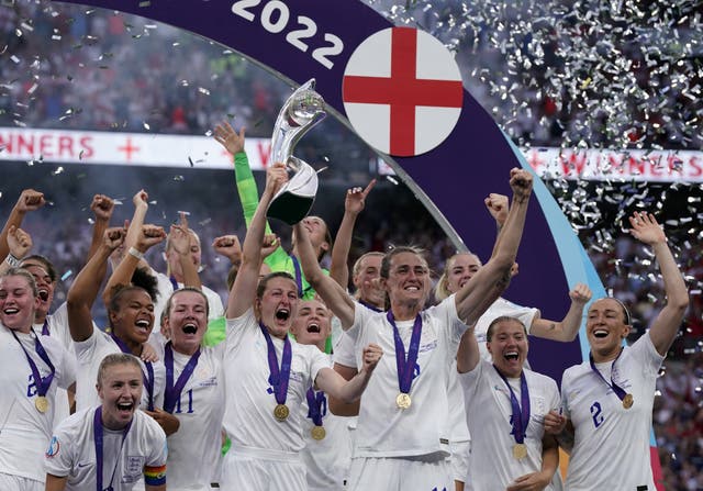 England’s Ellen White and Jill Scott celebrate with the trophy following Sunday’s victory over Gremany in the Euro 2022 final (Danny Lawson/PA).