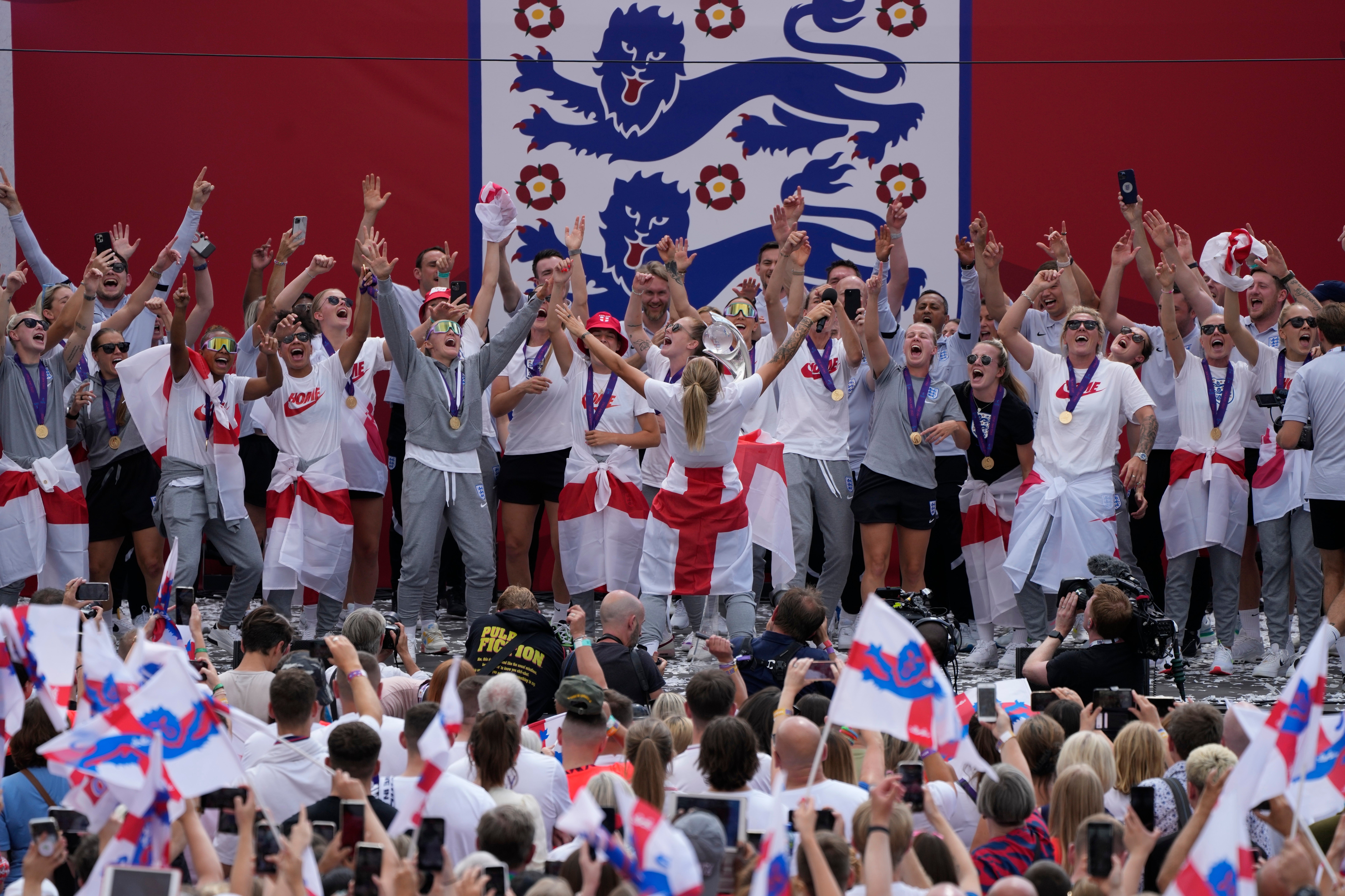 England players celebrate on stage with the crowd