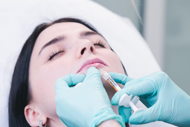 A botox injection in a woman’s lips. Ps are calling for stricter standards (Alamy/PA)
