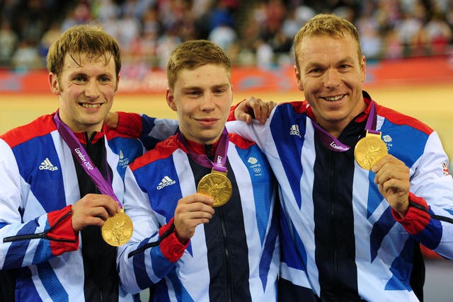 Great Britain’s Chris Hoy (right), Jason Kenny (left) and Philip Hindes after winning Gold in the Men’s Team Sprint during day six of the Olympic Games at the Velodrome, London (Adam Davy/PA)