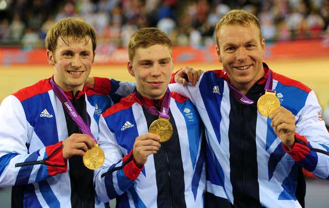 Great Britain’s Chris Hoy (right), Jason Kenny (left) and Philip Hindes after winning Gold in the Men’s Team Sprint during day six of the Olympic Games at the Velodrome, London (Adam Davy/PA)