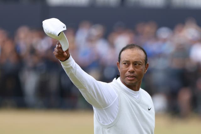 <p>Tiger Woods gestures to the crowd on the Old Course at St Andrews</p>