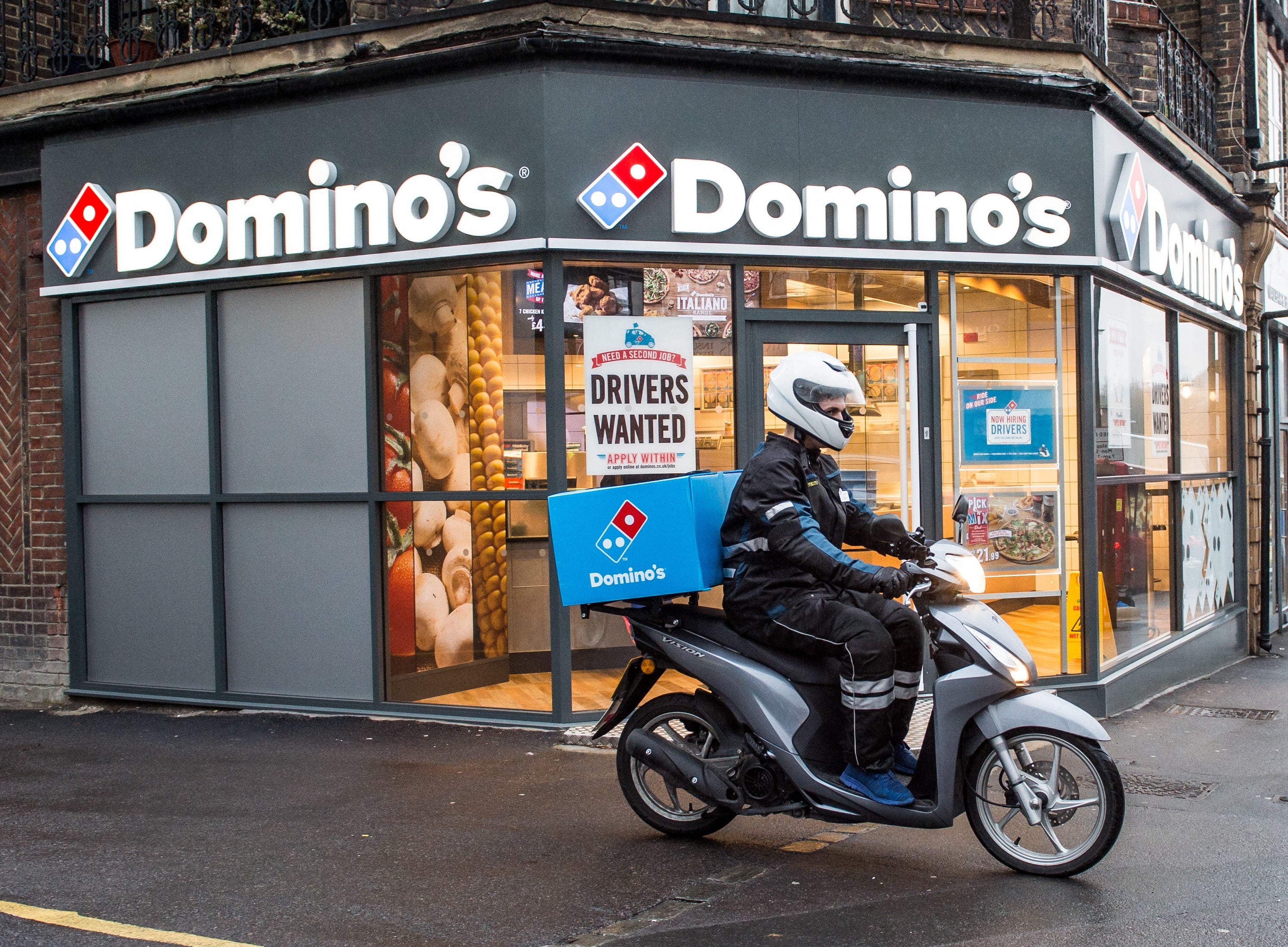 Domino’s Pizza has reported a slump in half-year profits (PA)