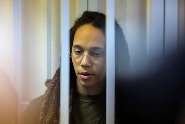 <p>WNBA star Brittney Griner stands behind bars in a courtroom for a hearing, in Khimki just outside Moscow, Russia, Tuesday, Aug. 2, 2022 </p>