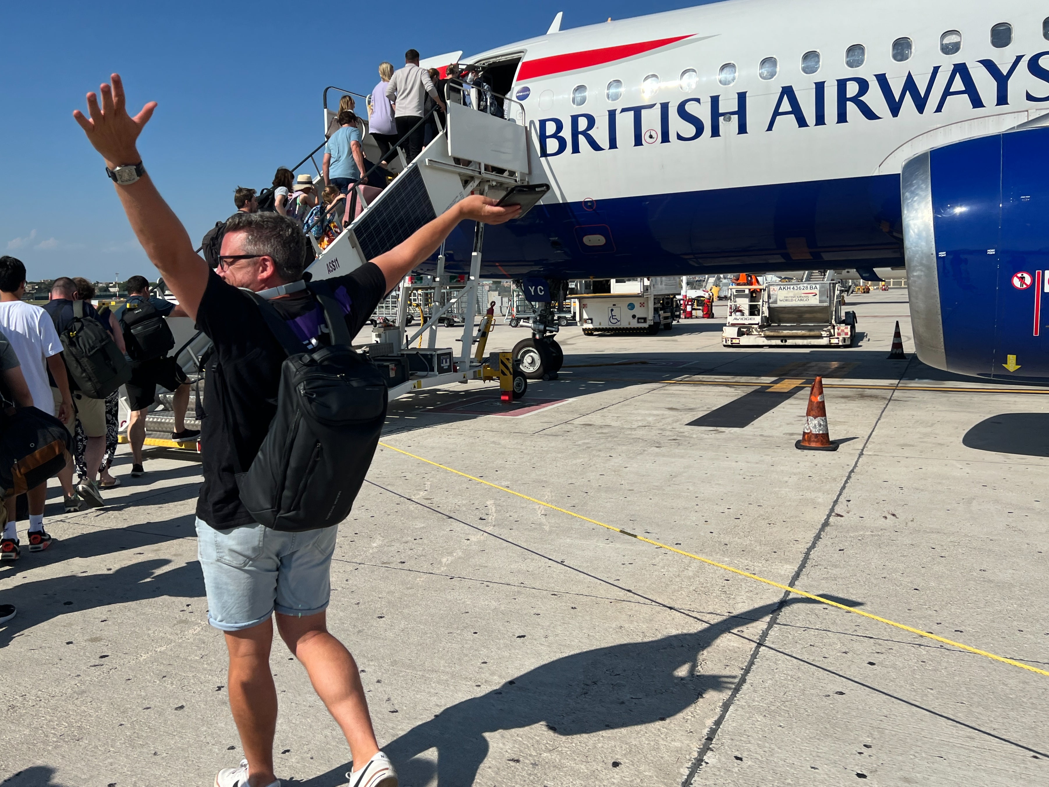 En route: British Airways passenger celebrates the imminent departure of a delayed flight to London Heathrow