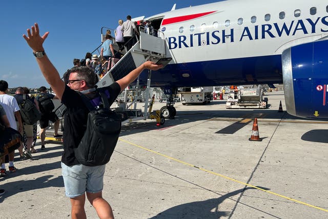 <p>En route: British Airways passenger celebrates the imminent departure of a delayed flight to London Heathrow </p>