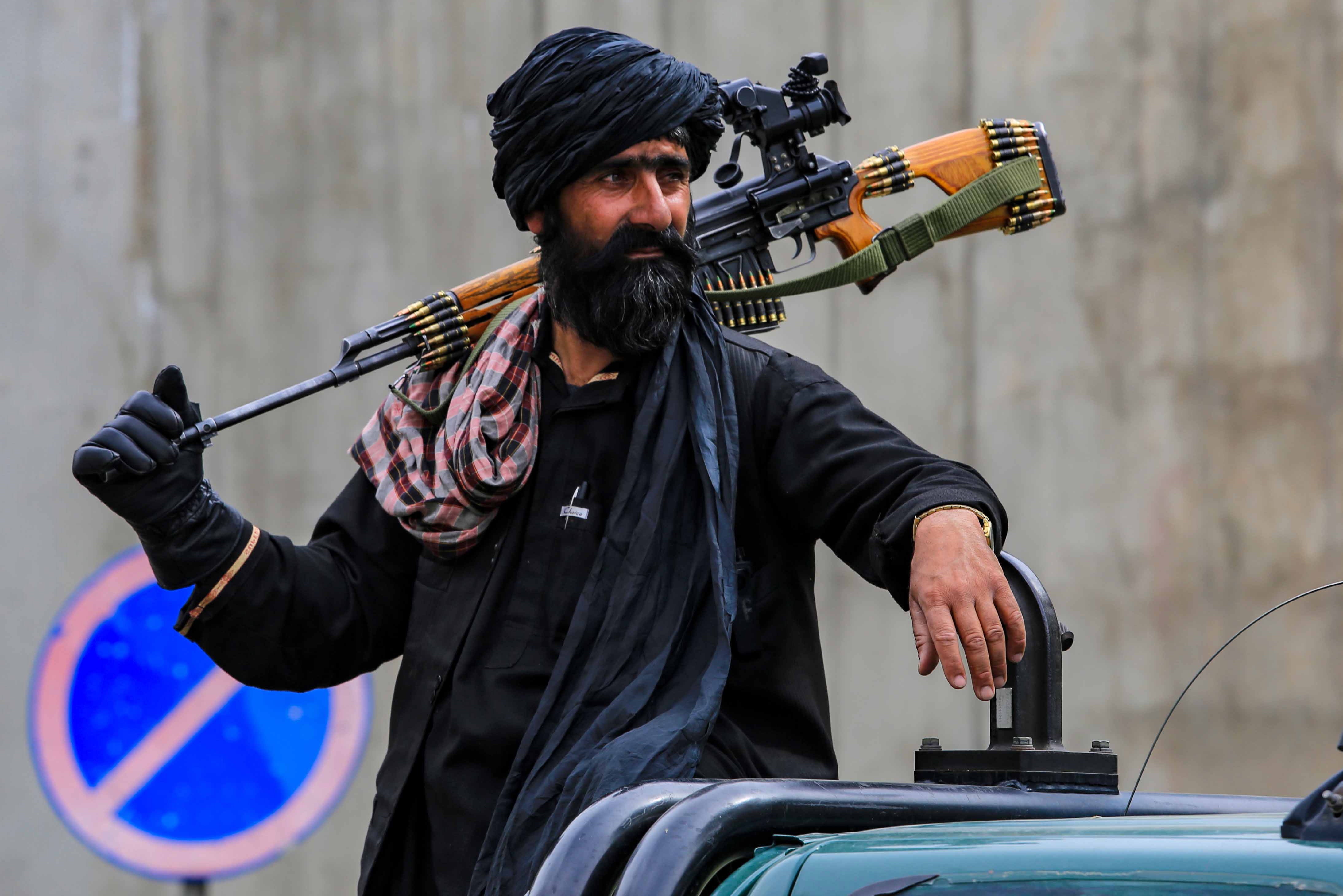 A Taliban security official guards the Kabul district that saw the attack