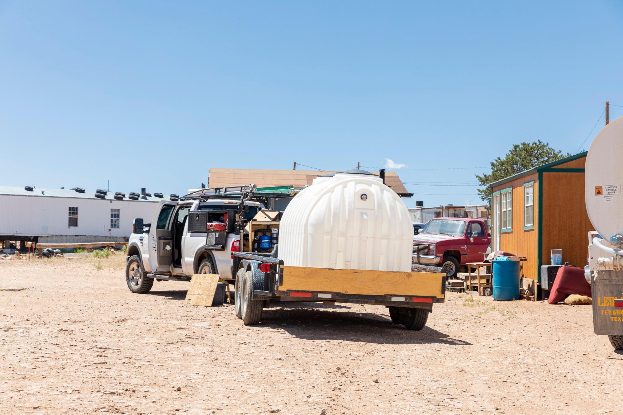 The Navajo Water Project team work on installing a 1,200-gallon tank at a family’s home outside of Prewitt, New Mexico