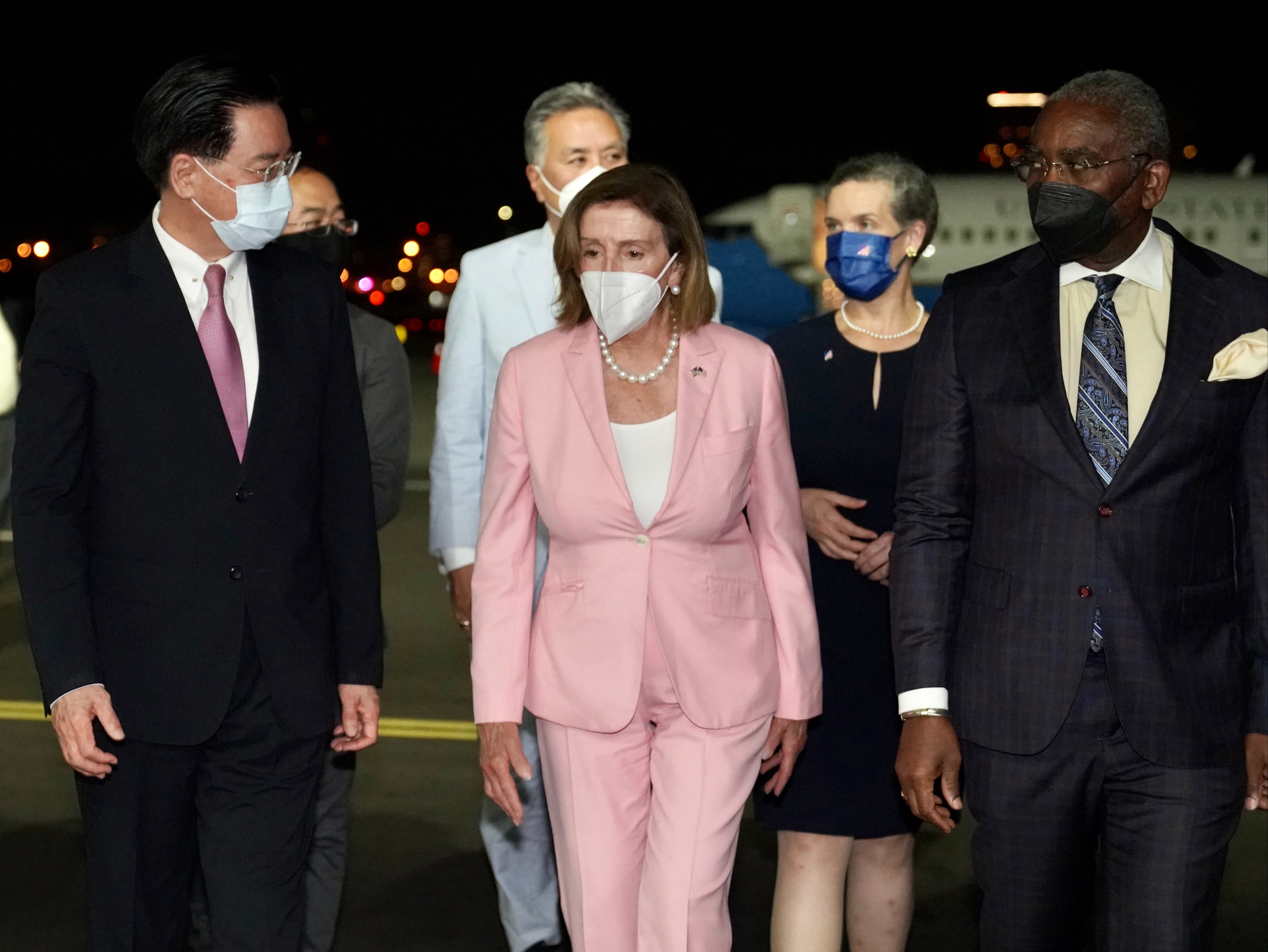 Nancy Pelosi, centre, was greeted by Taiwan foreign minister Joseph Wu, left, in Taipei