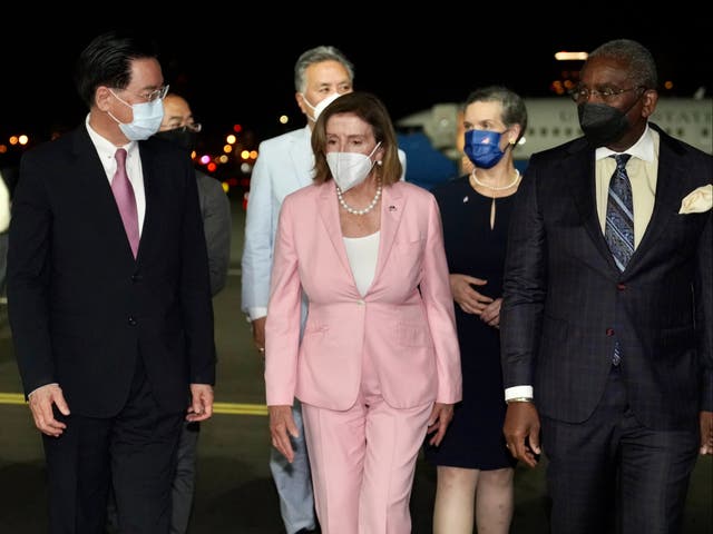 <p>Nancy Pelosi, centre, was greeted by Taiwan foreign minister Joseph Wu, left, in Taipei</p>