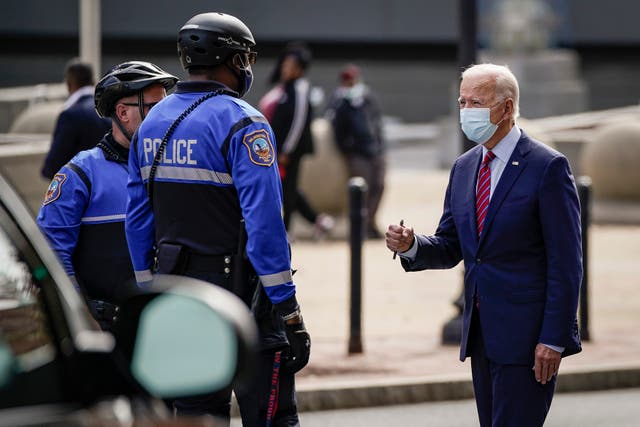 <p>Joe Biden greets police officers as he departs The Queen theater on October 19, 2020 in Wilmington, Delaware</p>