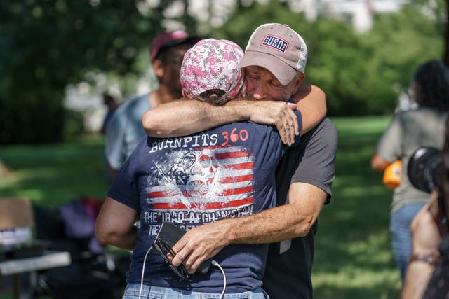 <p>Jon Stewart hugs a veteran campaigner </p>