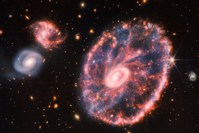 <p>The Cartwheel galaxy, located 500 million light years away, as seen by the James Webb Space Telescope’s near and mid-infrared instruments</p>