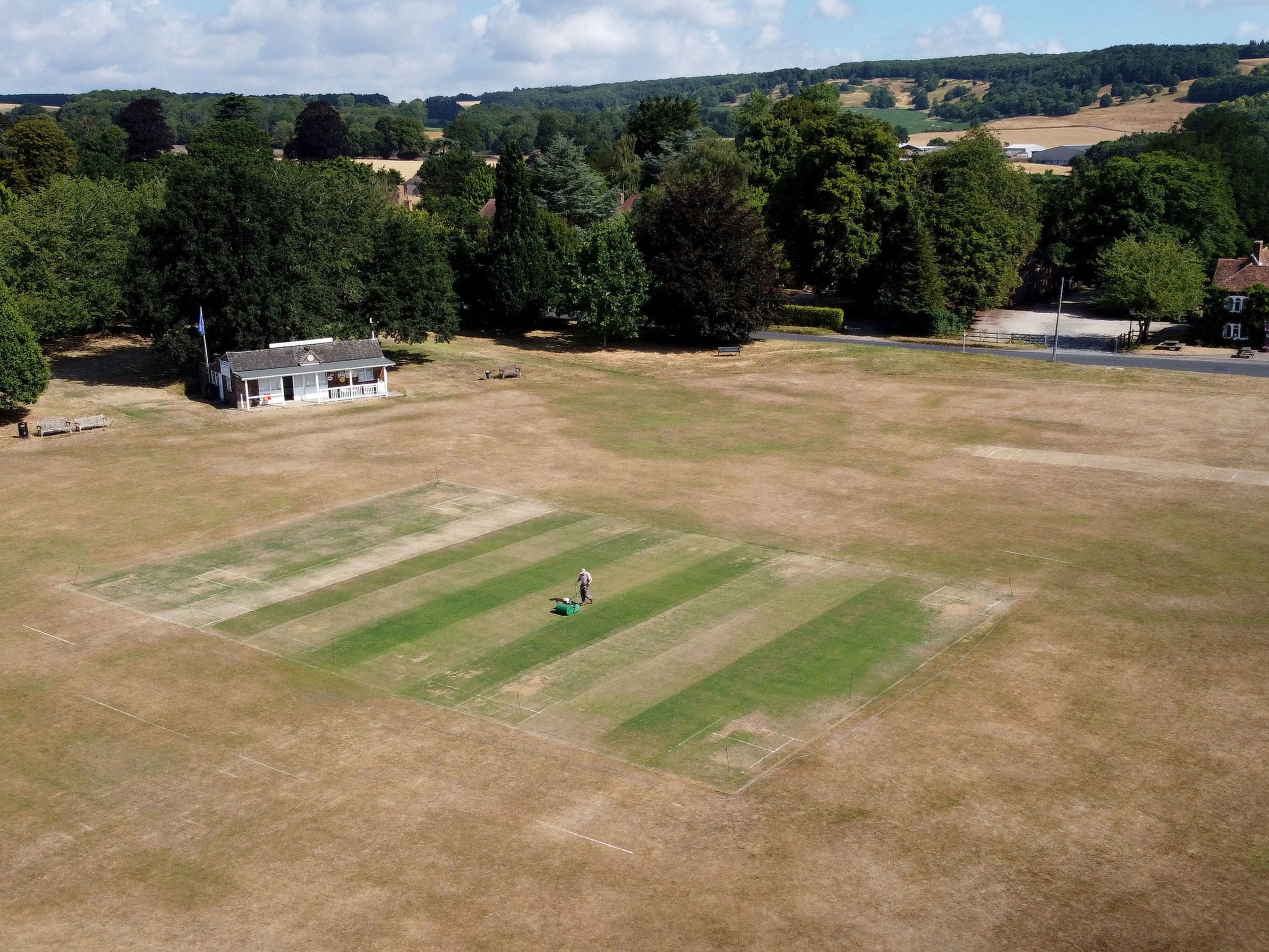 Vic Lilley, groundsman at Boughton and Eastwell Cricket Club in Ashford, Kent, prepares the wickets for matches this weekend