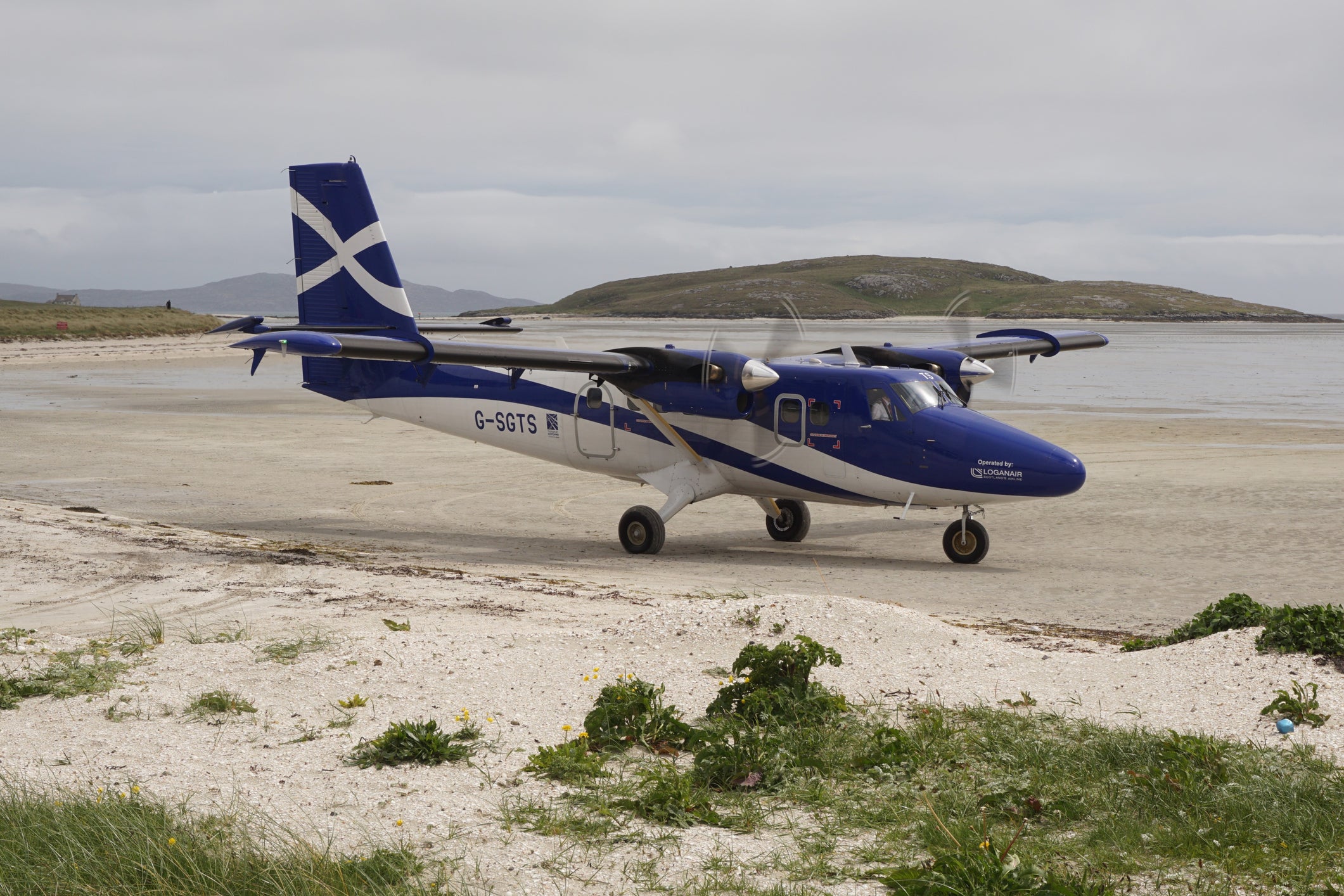 A small passenger plane on the runway for the small airport on the island of Barra