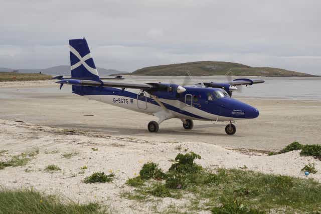 <p>A small passenger plane on the runway for the small airport on the island of Barra </p>
