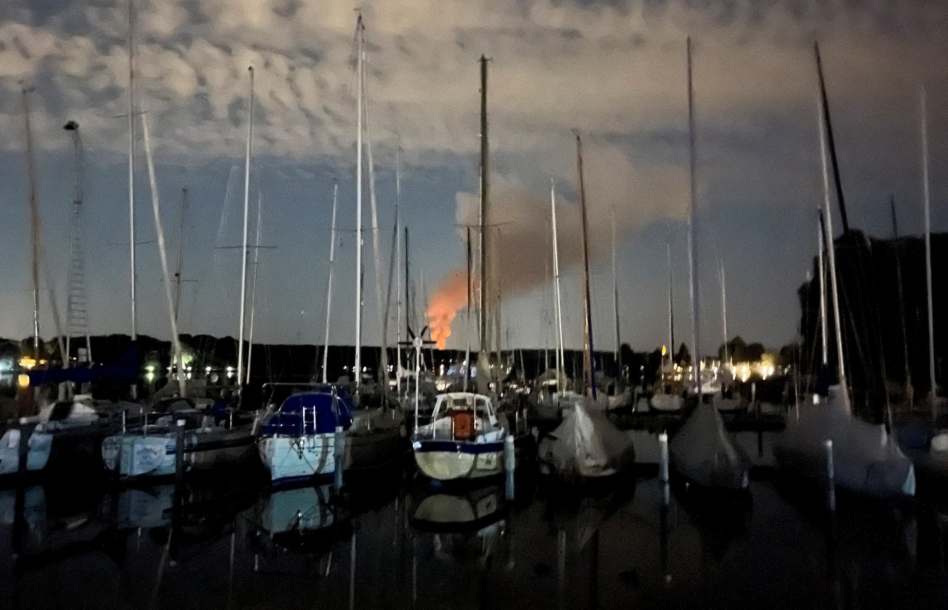 Smoke is seen in the distance from a harbour in the Berlin suburb of Spandau