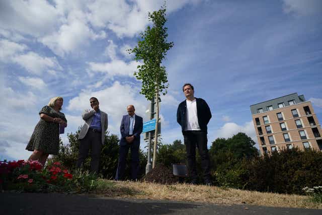 Doctor and best-selling author Adam Kay (right), plants a tree at Ealing Hospital, west London, in commemoration of NHS staff who have taken their own lives (Yui Mok/PA)