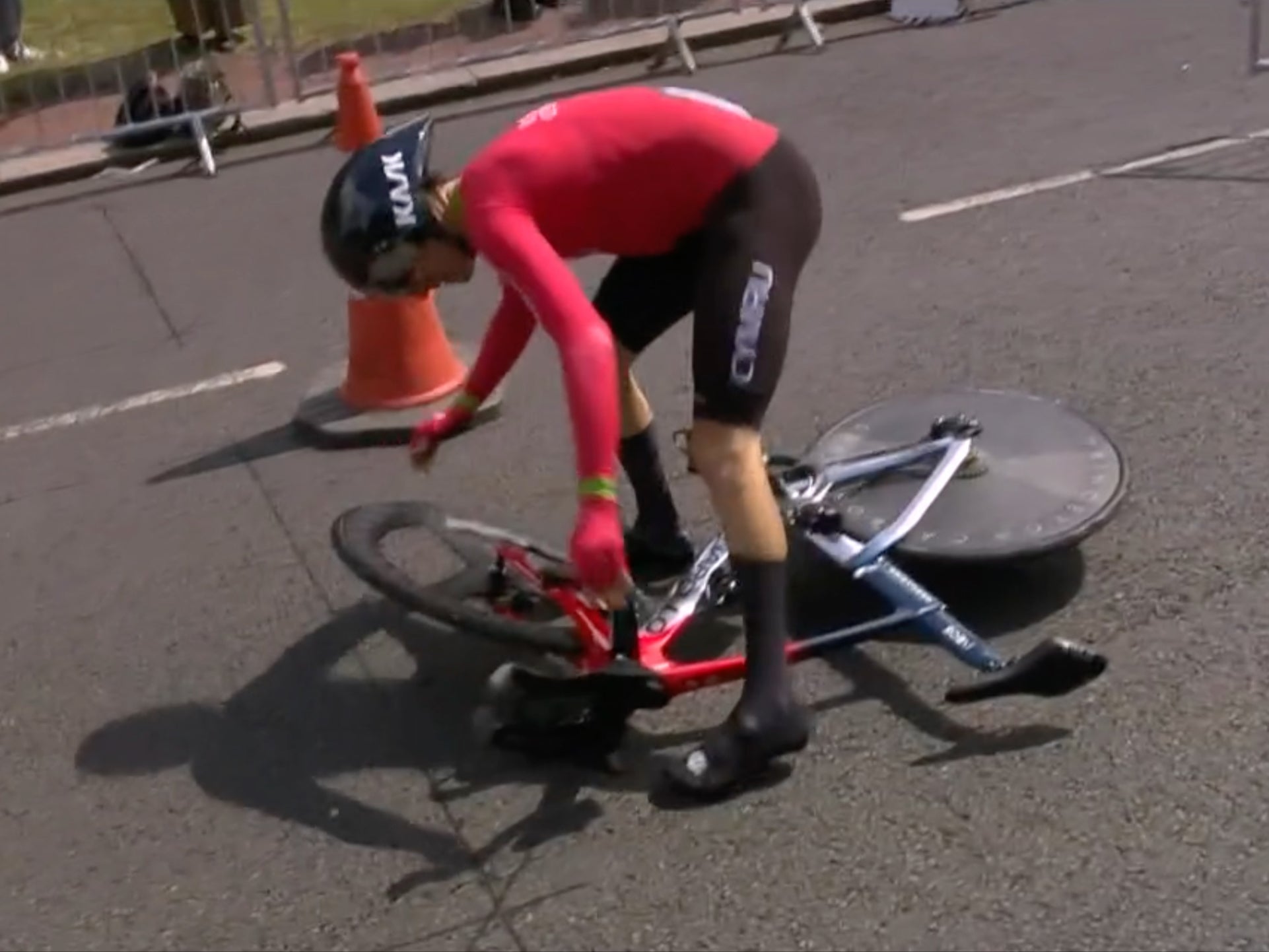 Geraint Thomas tries to remount after falling during the time trial