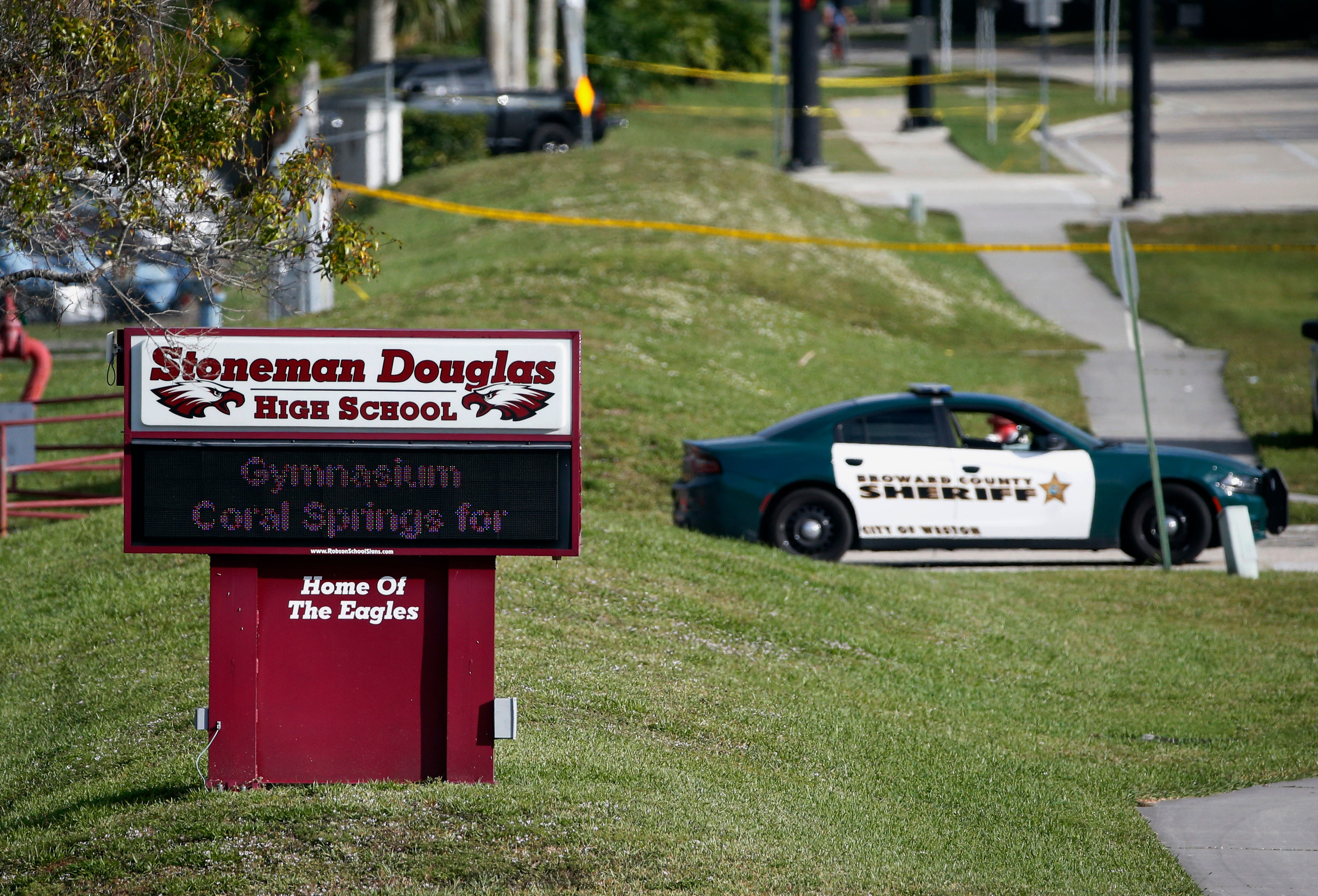 Law enforcement officers block off the entrance to Marjory Stoneman Douglas High School in Parkland on 15 February 2018