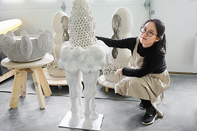 <p>Liang Wanying with some of her work in her studio   </p>