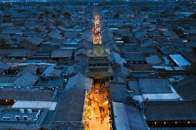 <p>A maze of grey-tiled rooftops is an iconic sight in the ancient town of Pingyao in Shanxi province</p>