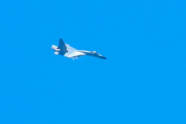 <p>A Chinese military jet flies over Pingtan island, one of mainland China’s closest point from Taiwan, in Fujian province</p>