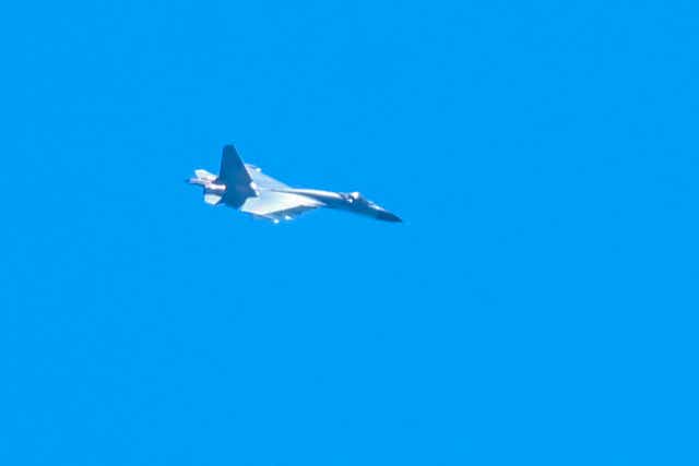 <p>A Chinese military jet flies over Pingtan island, one of mainland China’s closest point from Taiwan, in Fujian province</p>