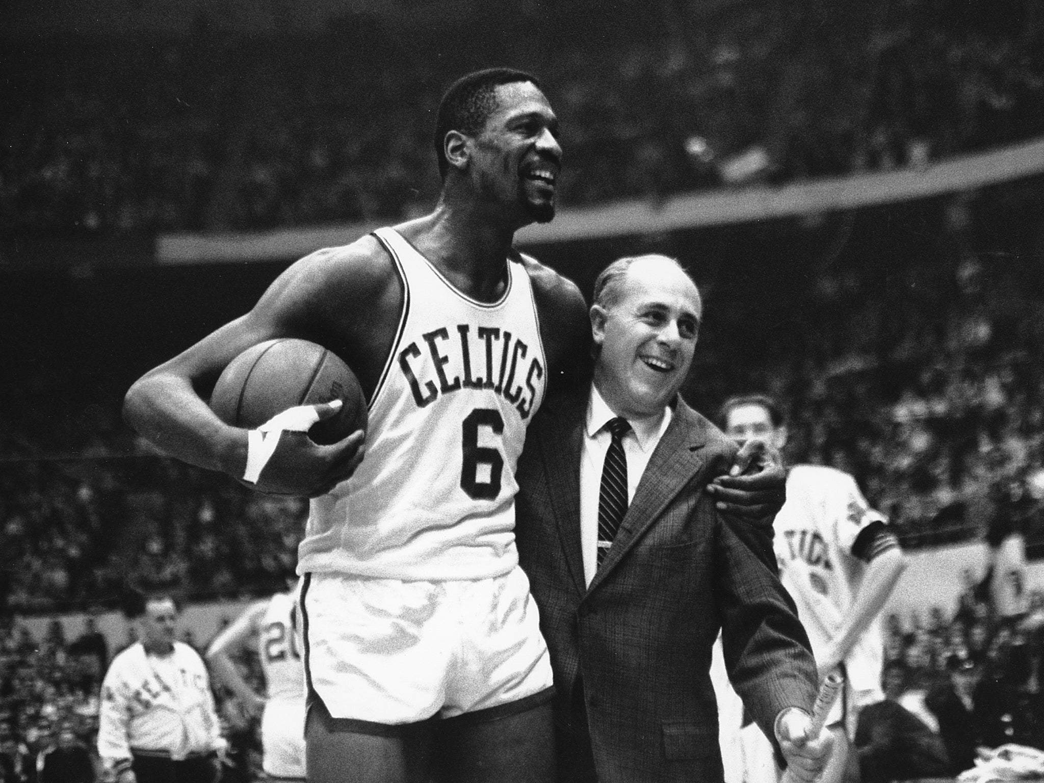 Russell is congratulated by coach Arnold ‘Red’ Auerbach after scoring his 10,000th point in the game against the Baltimore Bullets in Boston Garden on 12 December 1964