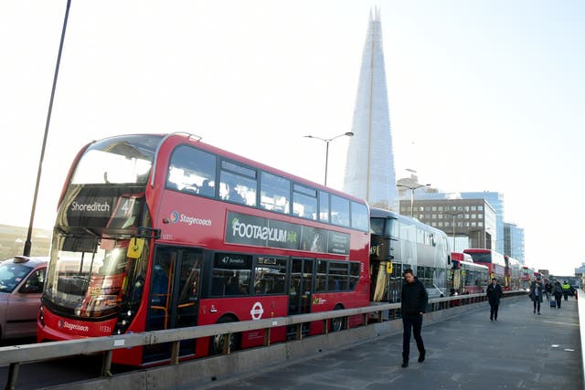 Buses on London Bridge in London (Ian West/PA)