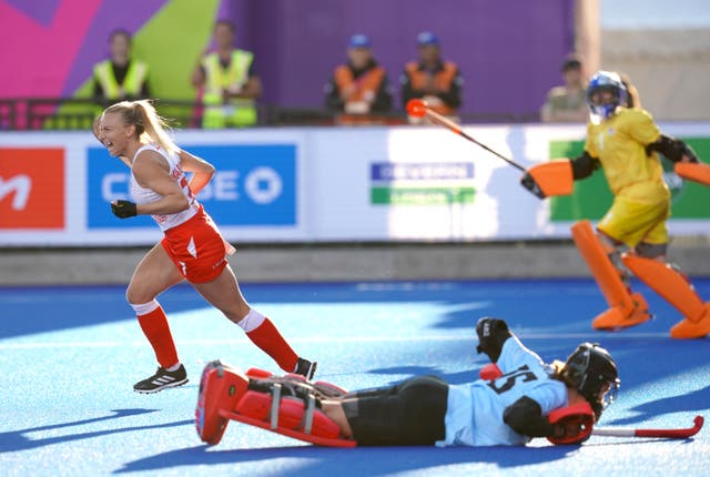 England’s Hannah Martin, left, celebrates after scoring her penalty in the women’s hockey semi-final against New Zealand (David Davies/PA)