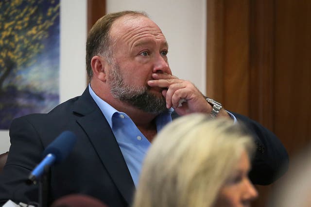 <p>Alex Jones under questioning from Mark Bankston, lawyer for Neil Heslin and Scarlett Lewis, during the defamation trial at the Travis County Courthouse in Austin on 3 August </p>