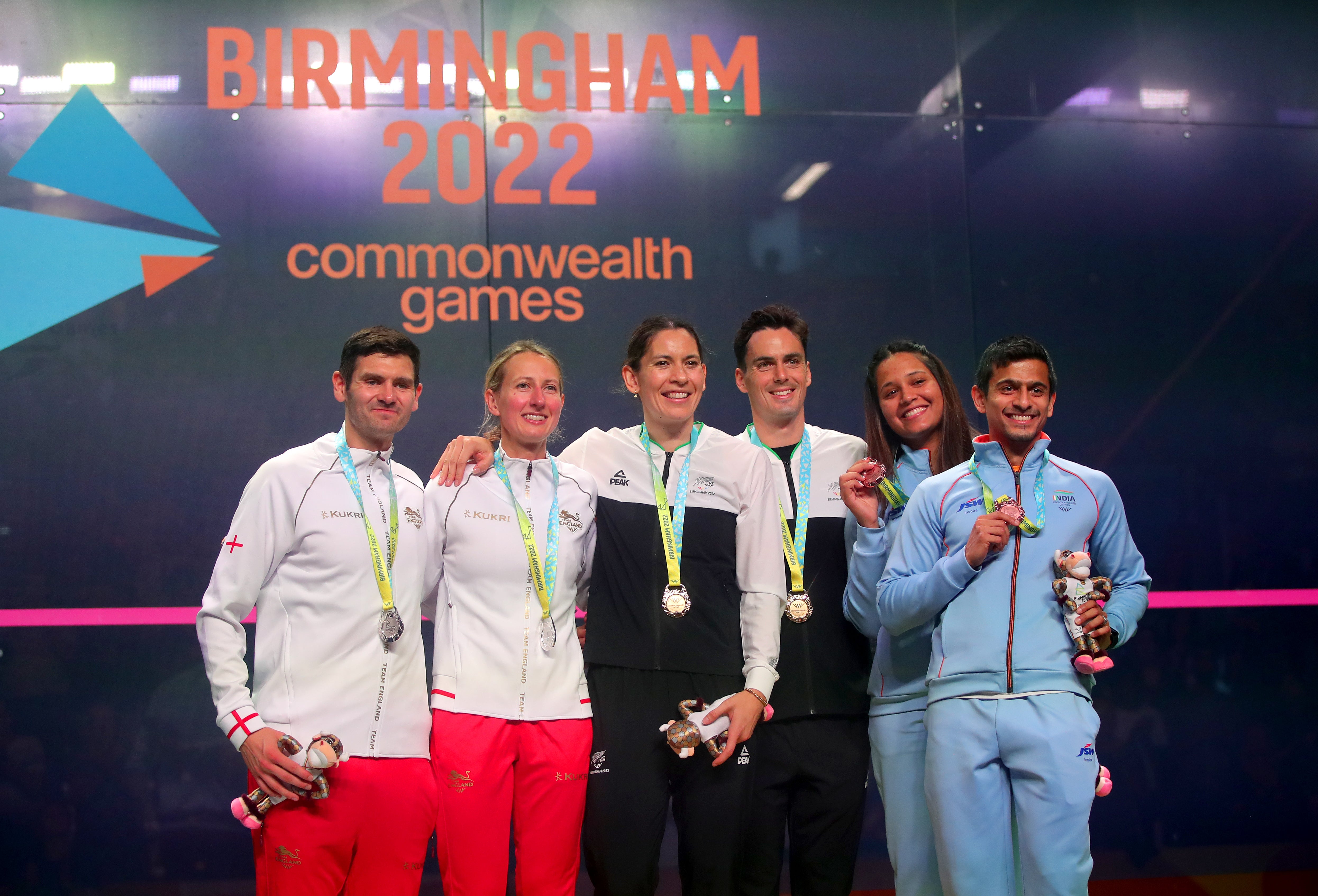 New Zealand’s Joelle King and Paul Coll (centre) celebrate with their squash mixed doubles gold medals at Birmingham 2022 (Simon Marper/PA)