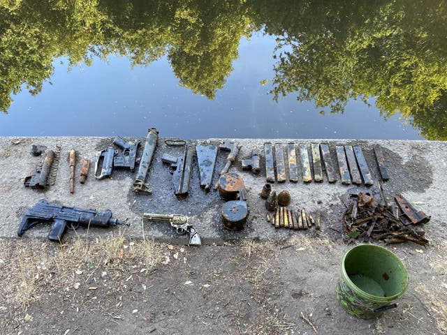 <p>The cache of dumped weapons found by a 15-year-old while he was paddling in a river in southeast London </p>