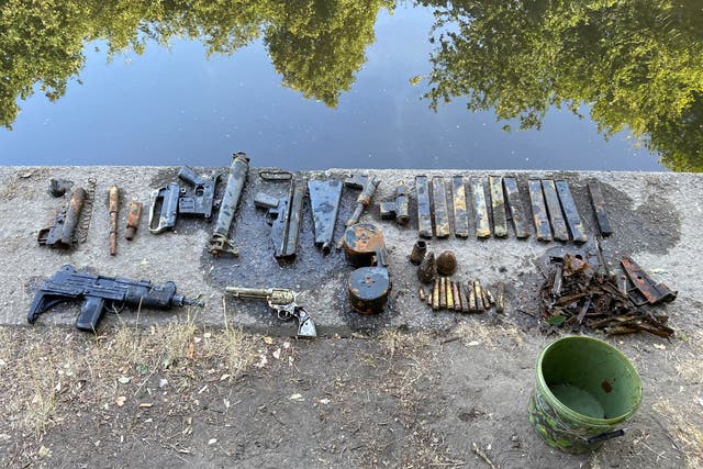 <p>The cache of dumped weapons found by a 15-year-old while he was paddling in a river in southeast London </p>