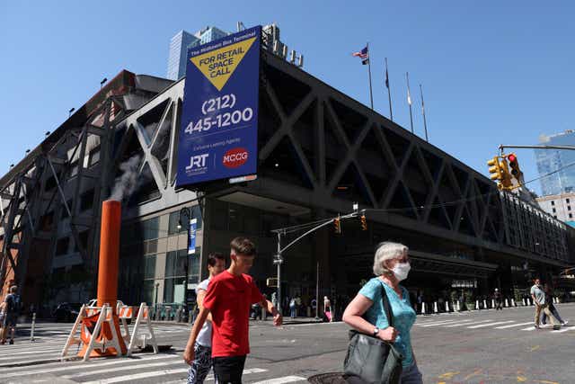 <p>People walk by the Port Authority Bus Terminal where earlier migrants arrived from Texas under the order of Governor Greg Abbott in Manhattan, New York City</p>