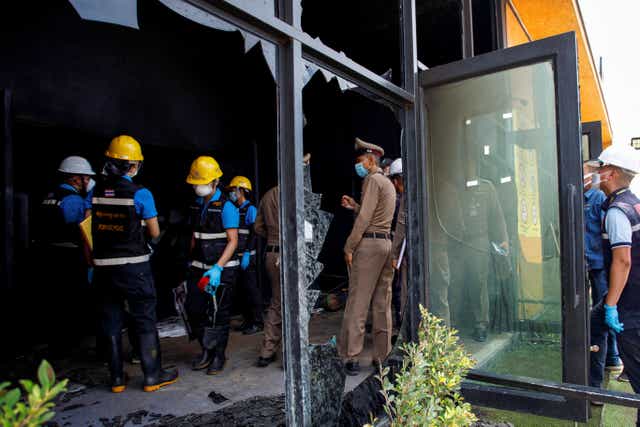 <p>Forensic and police officers investigate the Mountain B nightclub where at least 13 people were killed and 35 injured when a fire broke out early on Friday, in Chonburi province, Thailand, August 5, 2022. </p>