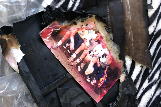 <p>Charred photographs at the Los Angeles home of Lynne Mishele after Friday’s crash</p>