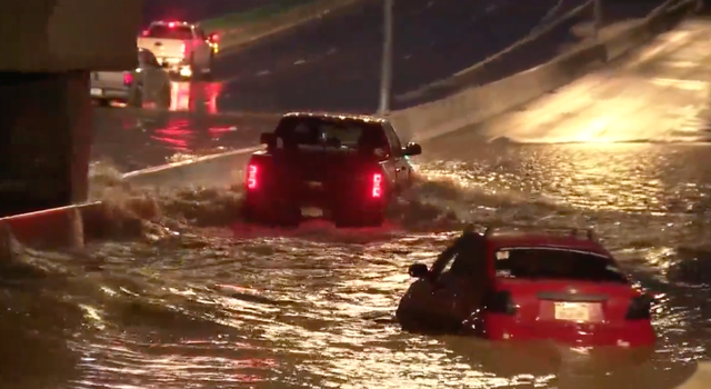 <p>Drivers attempt to escape the flash flooding that left about a dozen people being rescued from cars on Sunday night in Denver, Colorado</p>