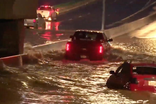 <p>Drivers attempt to escape the flash flooding that left about a dozen people being rescued from cars on Sunday night in Denver, Colorado</p>