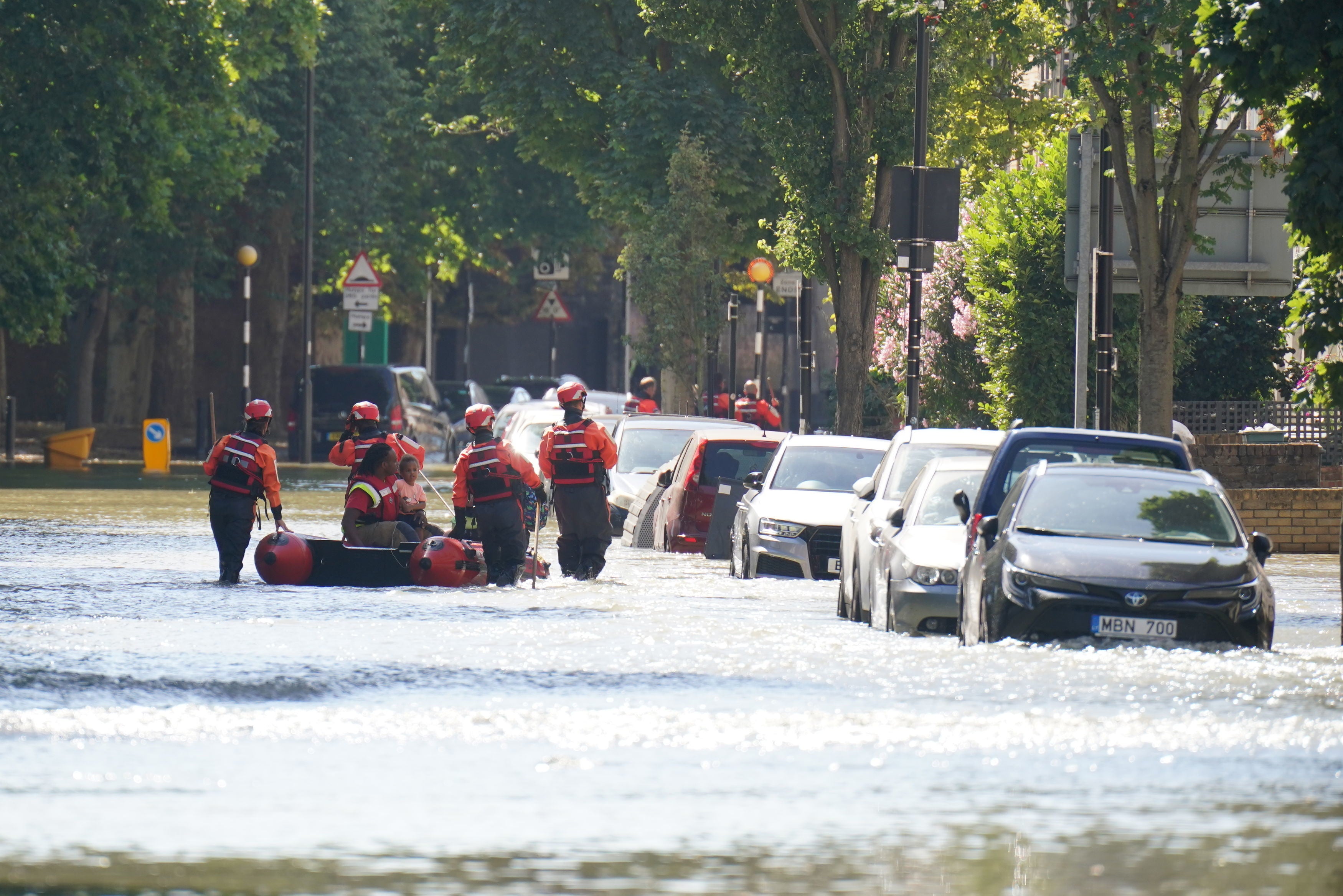 London Fire Brigade help ferry residents along Hornsey Road in north London after a water main burst, causing flooding up to 4ft deep