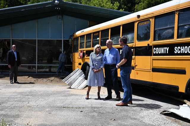 <p>President Joe Biden and First Lady Jill Biden speak with Andy Beshear, Governor of Kentucky (R), as they survey damage caused by deadly flooding while on their way to a briefing on the ongoing response efforts at Marie Roberts Elementary School, in Lost Creek, Kentucky, on August 8, 2022</p>
