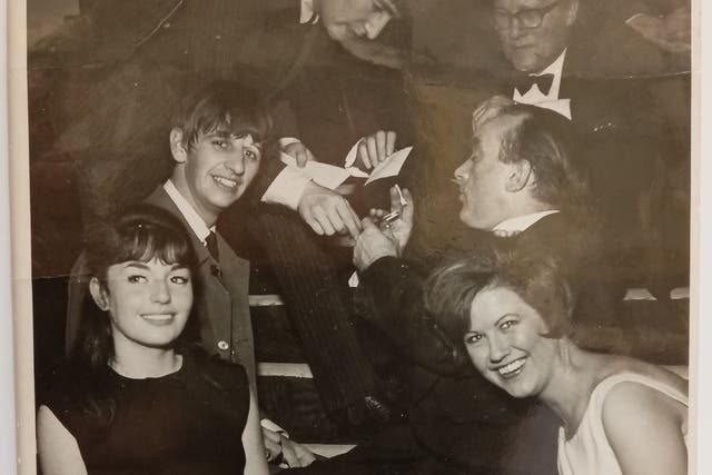 John Lennon signs an autograph at the 1963 Royal Variety Performance with Ringo Starr in the foreground (The Beatles Shop/PA)