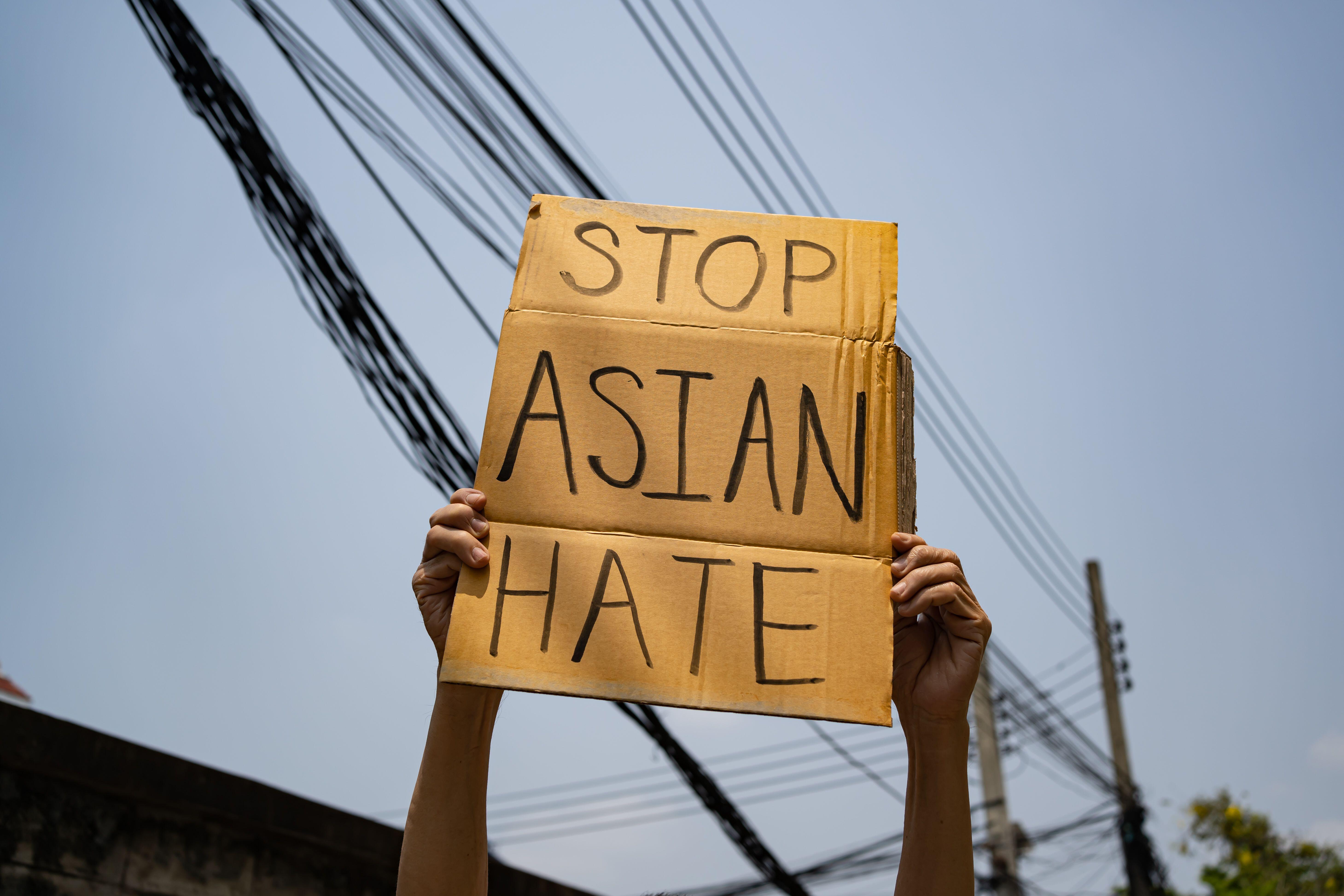 A man holding Stop Asian Hate sign (Wachiwit / Alamy Stock Photo)