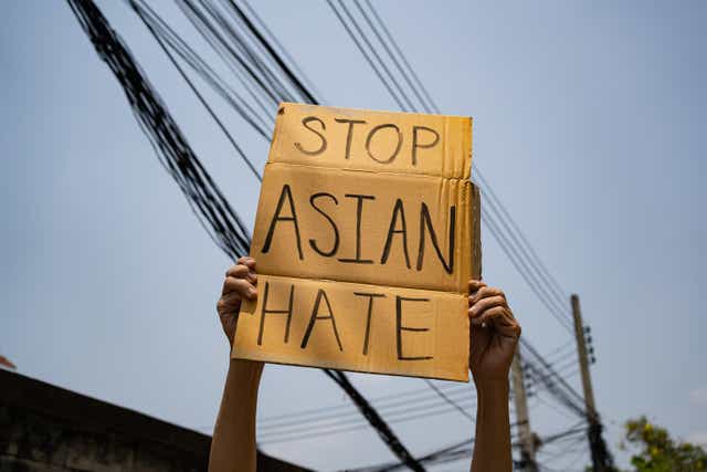 A man holding Stop Asian Hate sign (Wachiwit / Alamy Stock Photo)